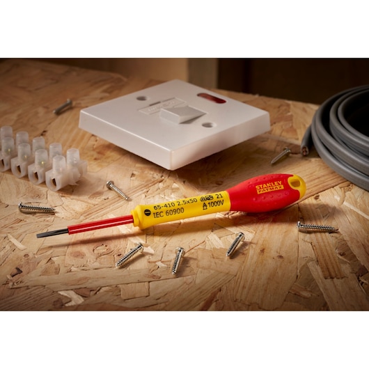 STANLEY® FATMAX® Insulated Slotted 2.5mm x 50mm Screwdriver Environment Shot In a Workshpt Background