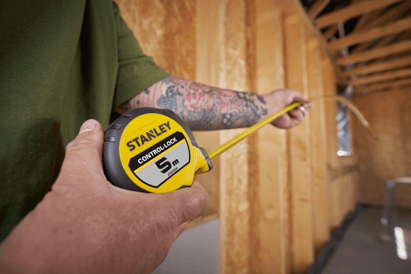 STANLEY® CONTROL-LOCK™ 5M (25mm wide) Tape Measure being used by worker on site in extended reach position