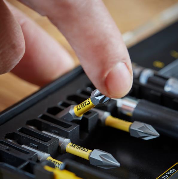 STANLEY STA88558 embouts de tournevis dans un coffret jaune et noir, gros plan d'une main prenant un embout.