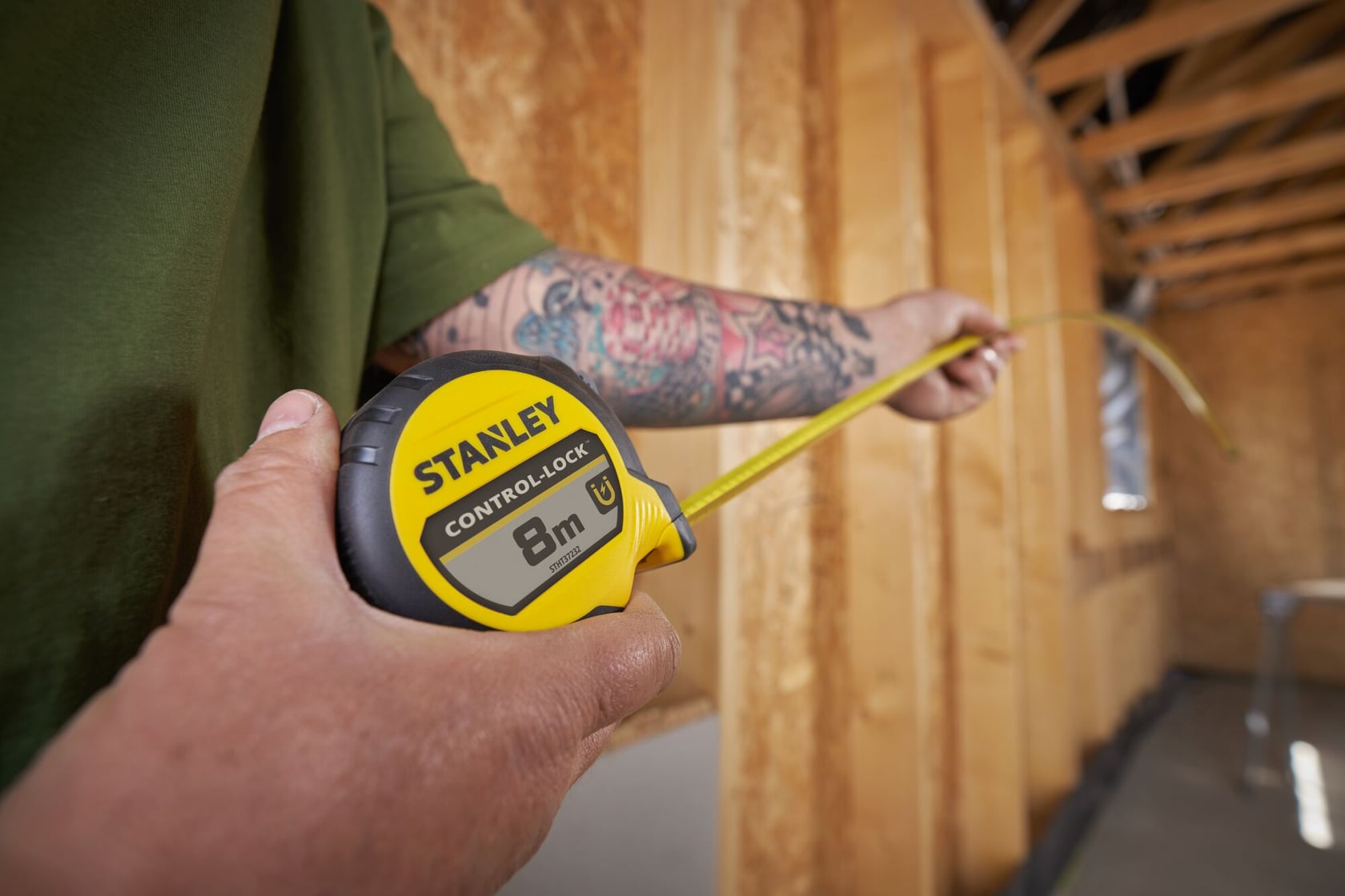 STANLEY® CONTROL-LOCK™ 8M (25mm wide) Tape Measure being used by worker in extended reach to measure